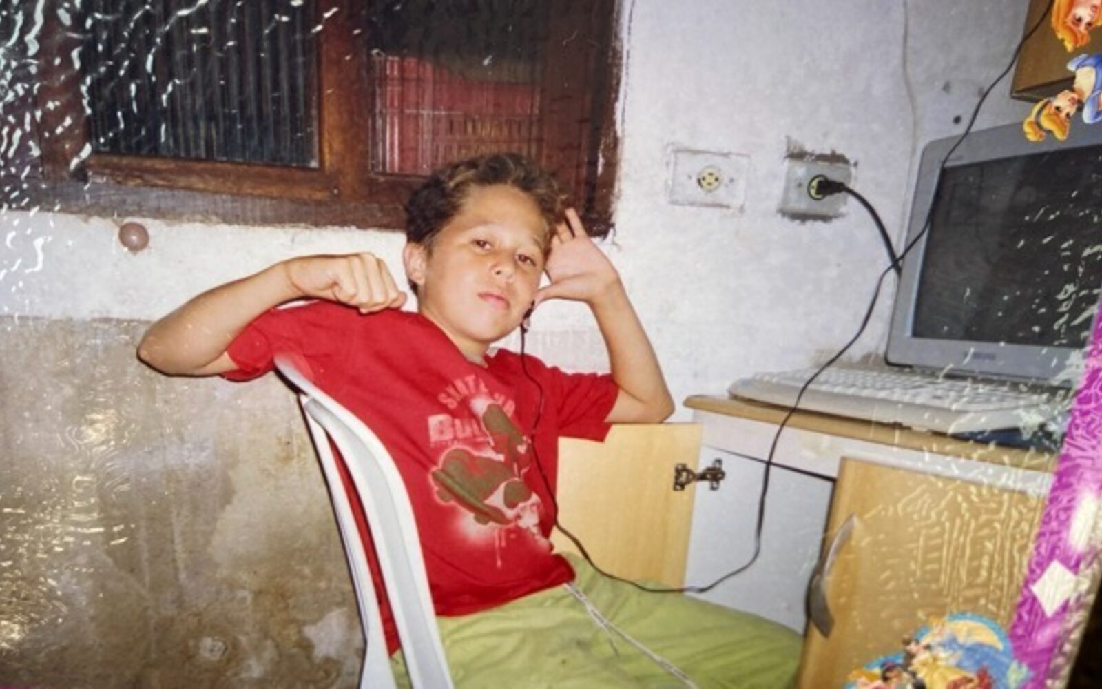 Bruce as a kid, next to an old CRT PC.